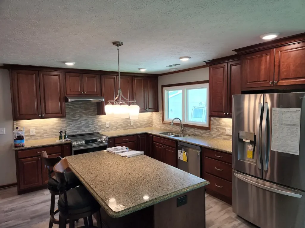 Modern kitchen with granite island and stainless appliances
