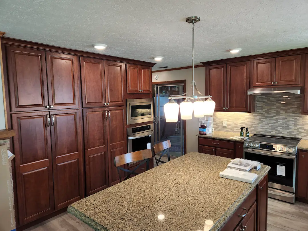 Modern kitchen with wooden cabinets and granite island
