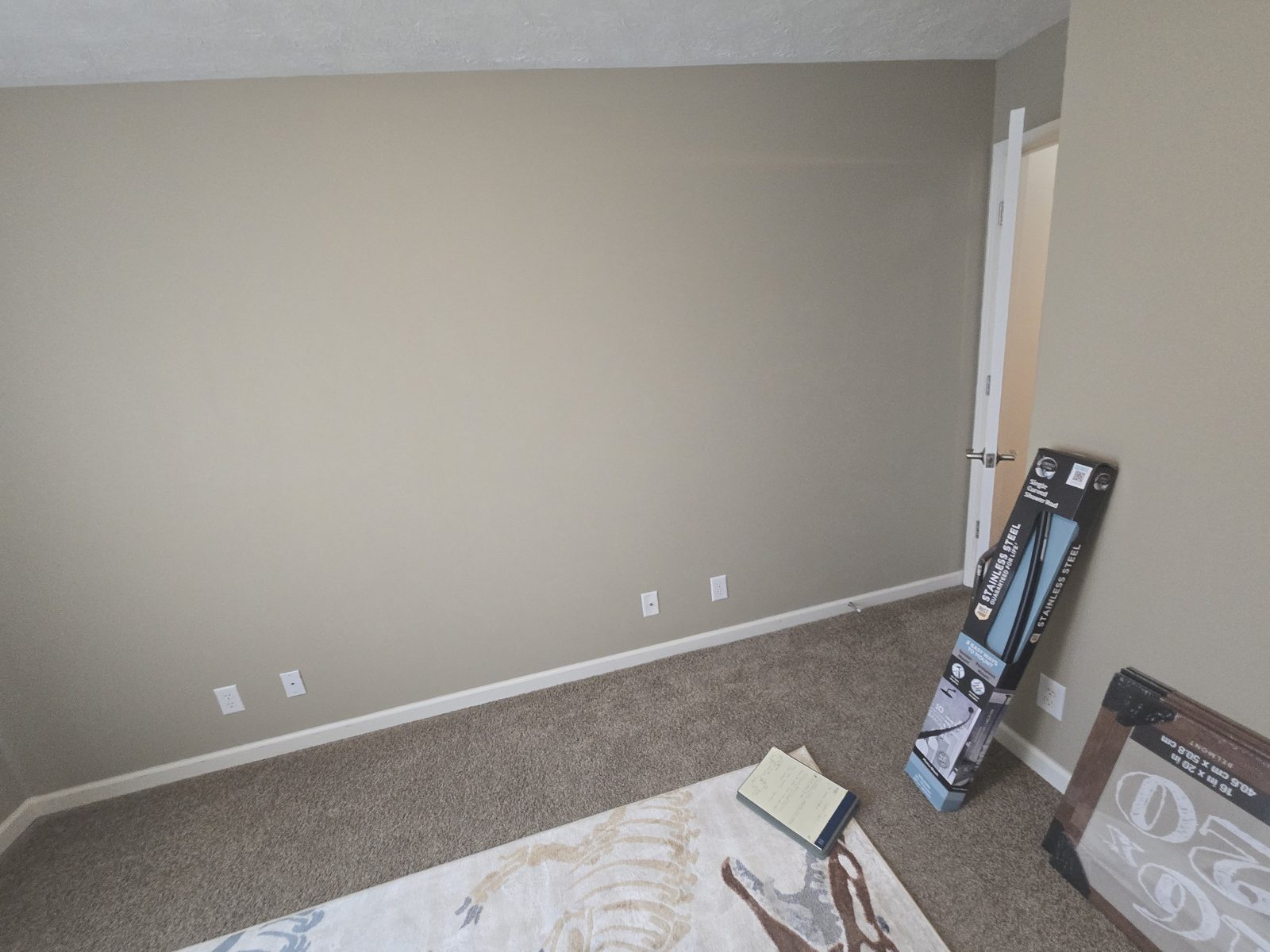 Bare tan wall in a Lafayette bedroom before picture frame paneling