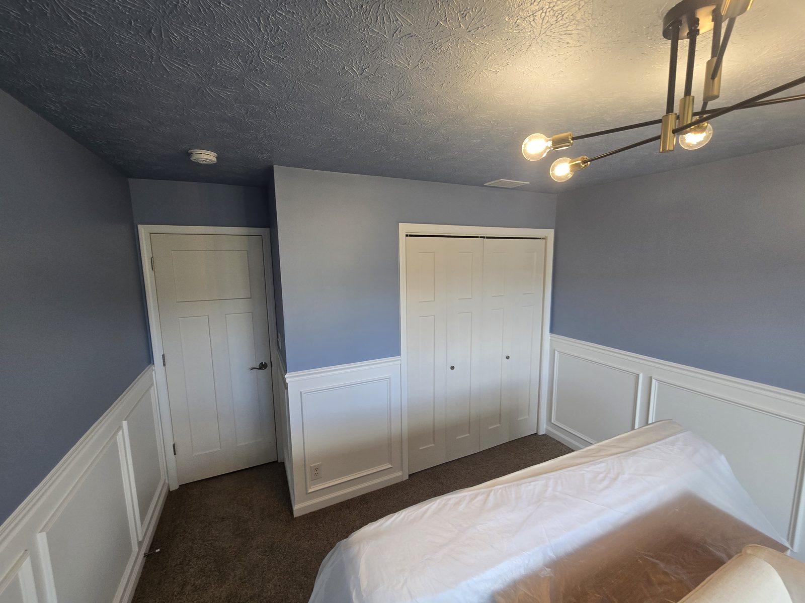 Paneling carried around the closet and door wall of a Lafayette bedroom