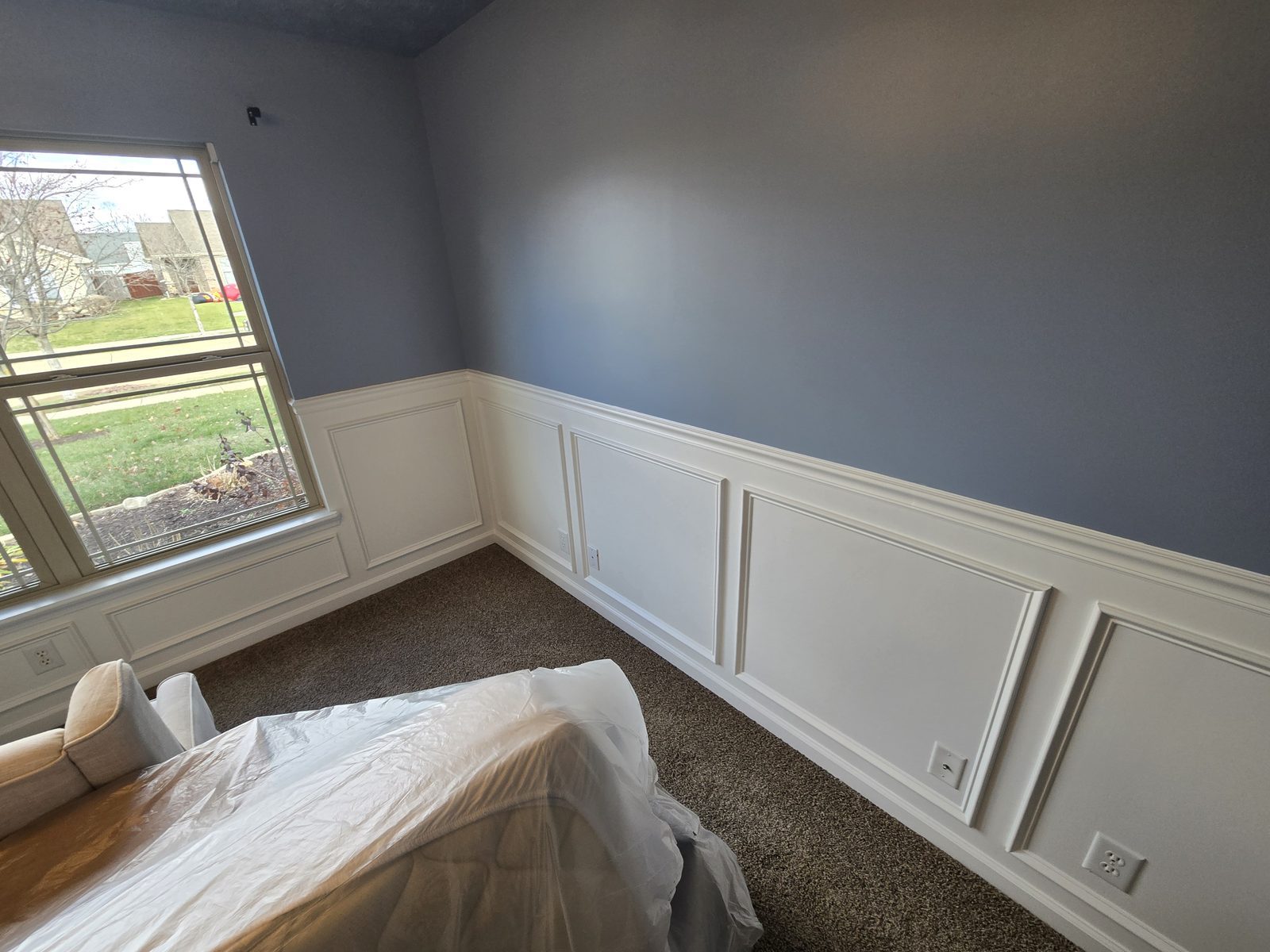 Wainscoting carried past the window in a Lafayette bedroom