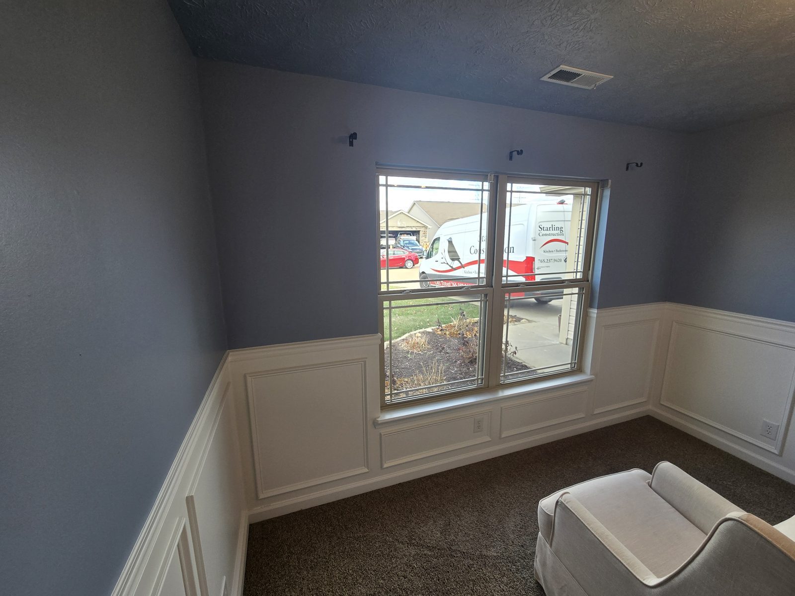 Finished window wall in a Lafayette bedroom, with the Starling Construction van outside