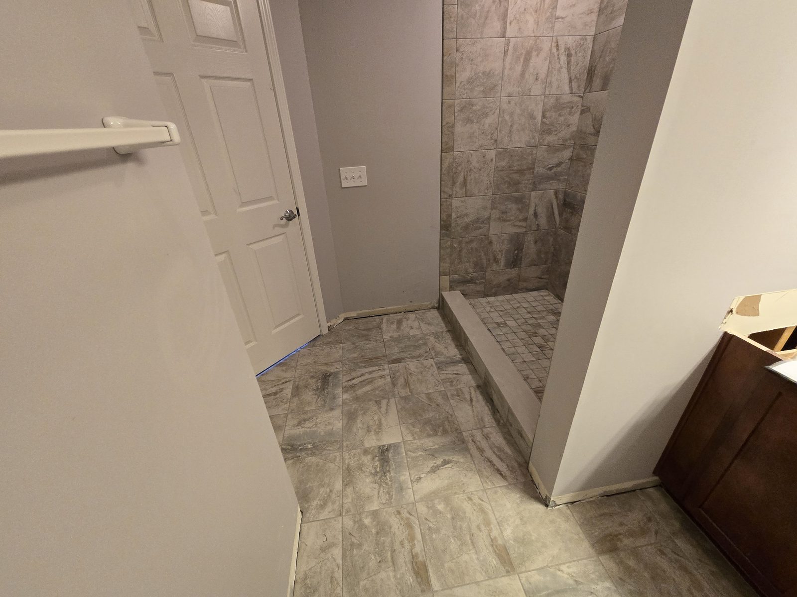 Large format floor tile running out of the shower across a Lafayette bathroom