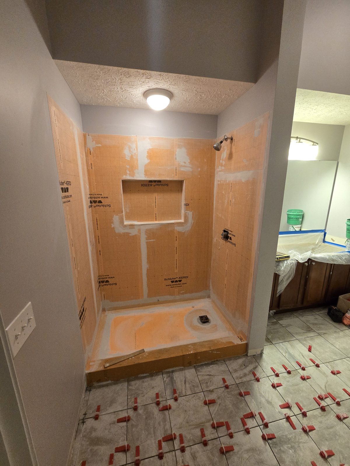 Waterproofed shower with the bathroom floor tile being set on leveling clips in Lafayette