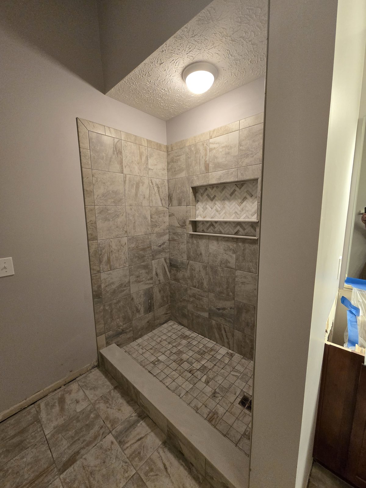 Finished tile shower and curb in a Lafayette bathroom