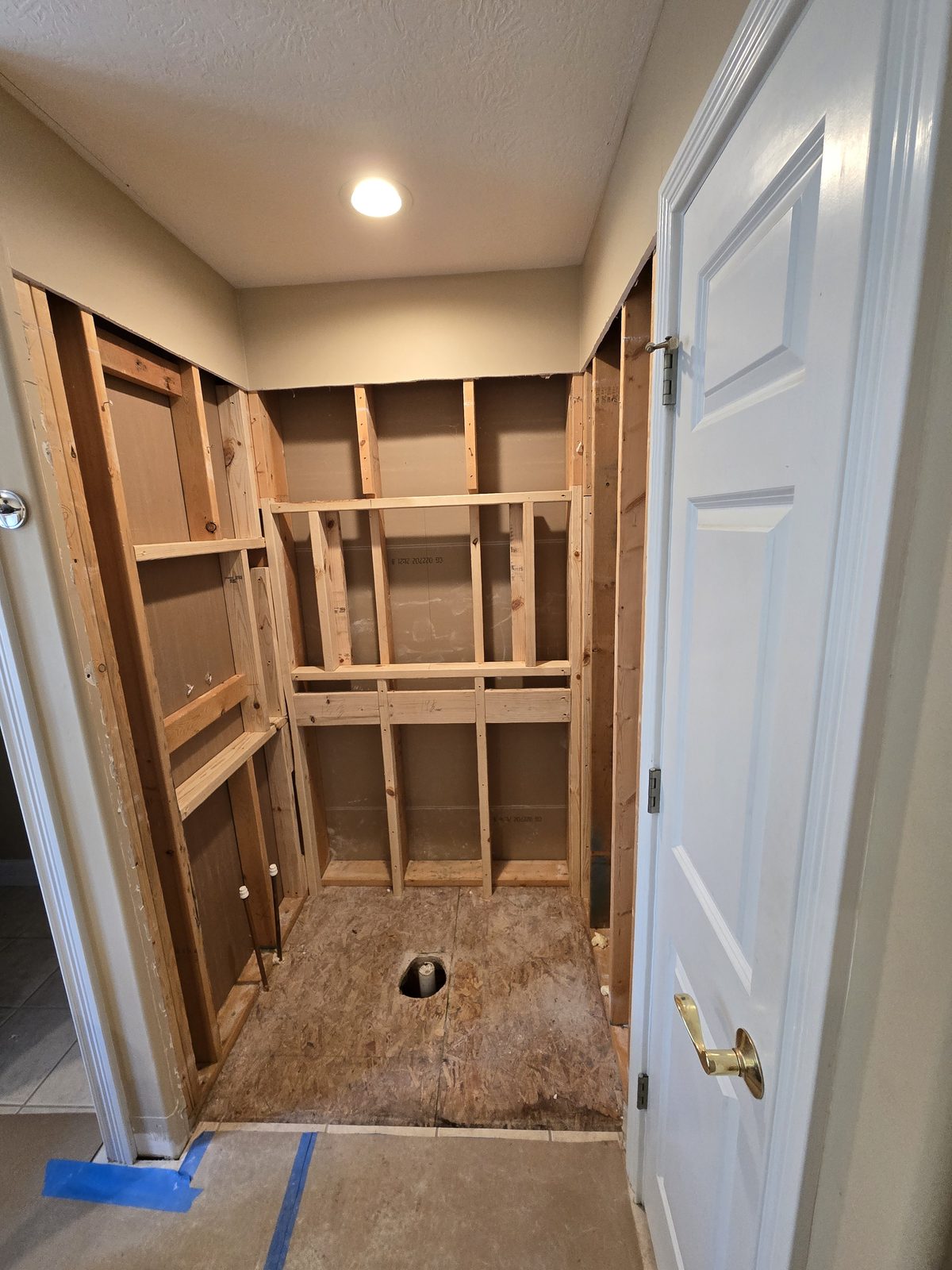 The stripped shower alcove seen from the bathroom doorway in West Lafayette