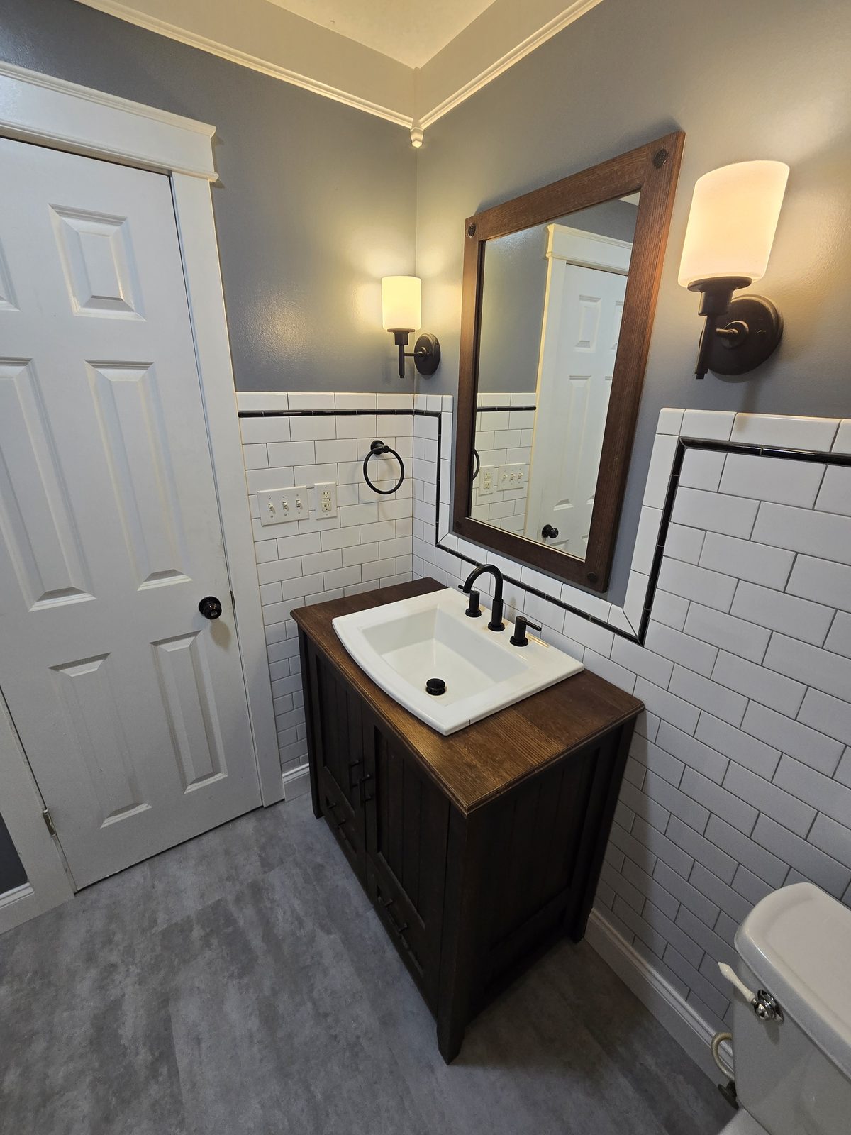 Finished West Lafayette bathroom with subway tile wainscoting and new vinyl plank floor