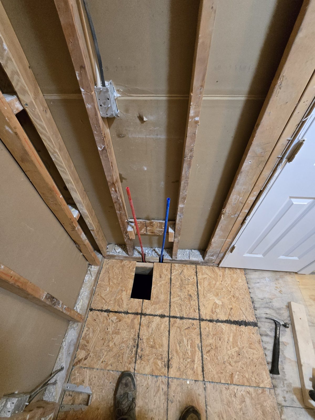 New subfloor sheathing and reworked hot and cold supply lines in a West Lafayette bathroom