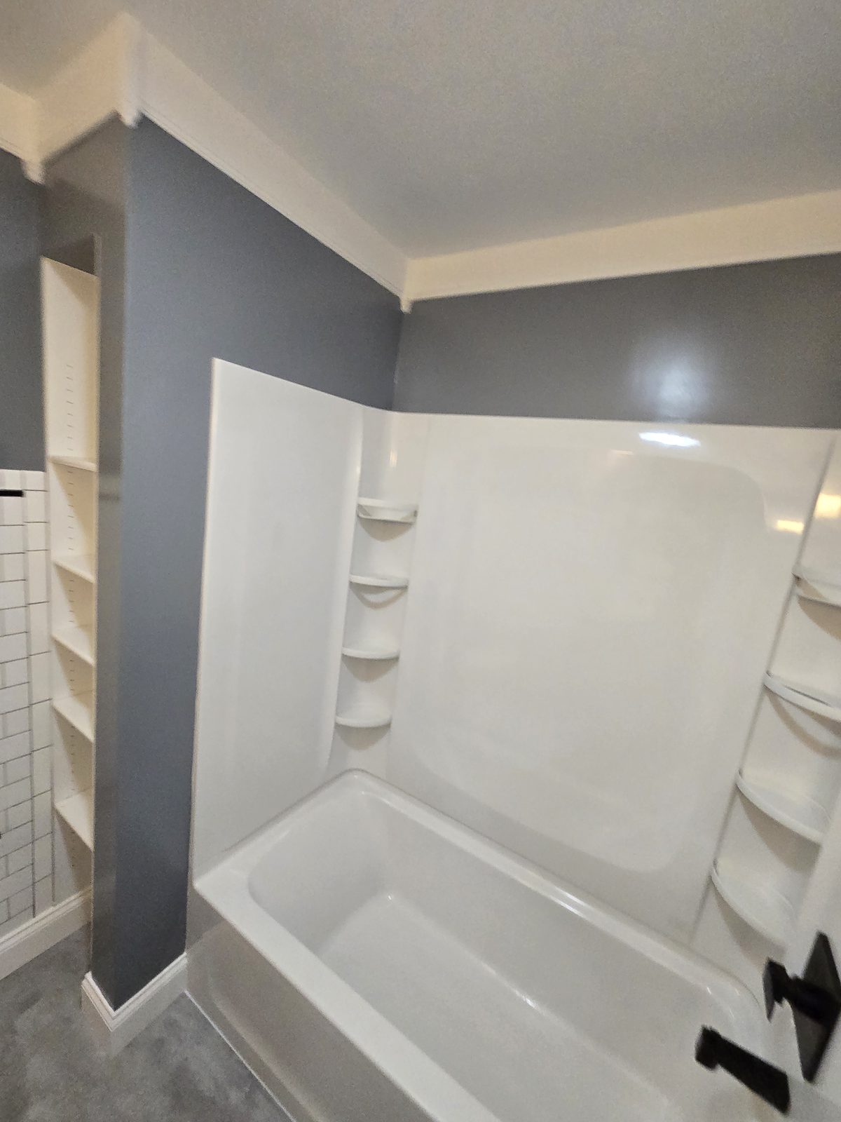 New tub and shower beside the existing built in linen shelving in West Lafayette