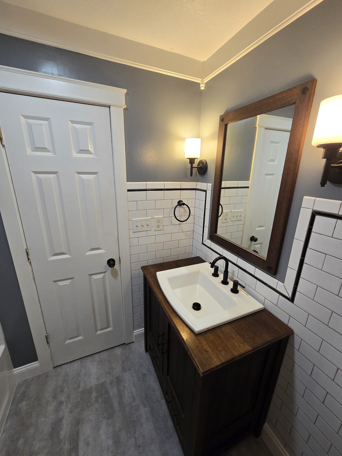 Vanity wall with existing subway tile wainscoting in a finished West Lafayette bathroom